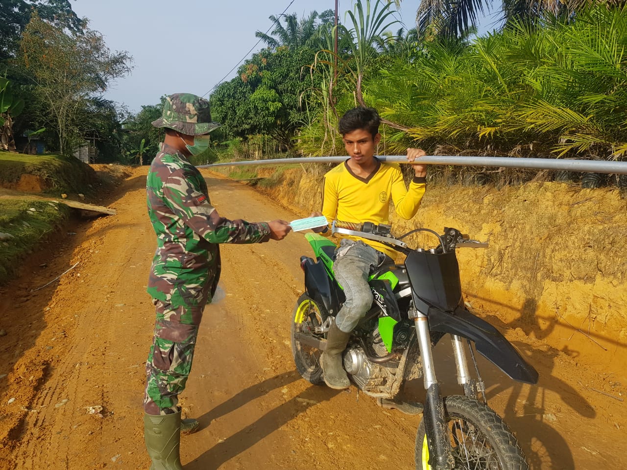 Anggota Satgas TMMD bagikan masker pada warga